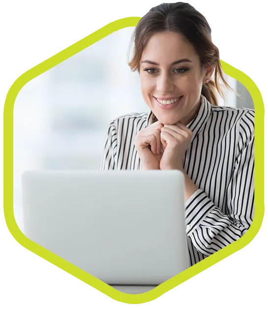 Light-skinned twenty-something woman reads on her laptop.